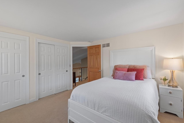 bedroom featuring visible vents and light colored carpet