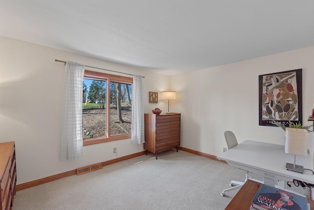 carpeted office space with visible vents and baseboards