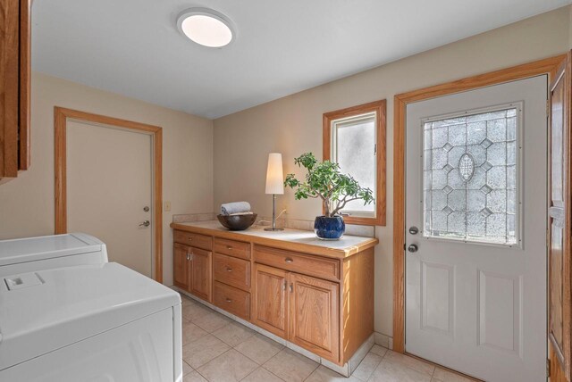 laundry area featuring plenty of natural light, laundry area, and light tile patterned floors