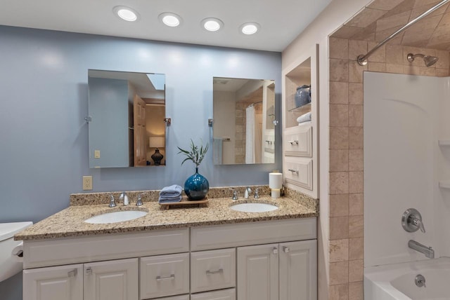 full bathroom with washtub / shower combination, double vanity, toilet, and a sink