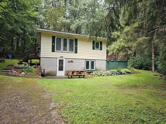 W5691 Cedar Trl, Neshkoro, WI 54960 - rear view of house with stairs and a yard