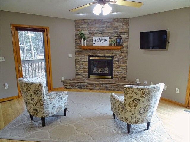 N1698 945th St, Eau Claire, WI 54701 - living room with ceiling fan, baseboards, a fireplace, and light wood-type flooring