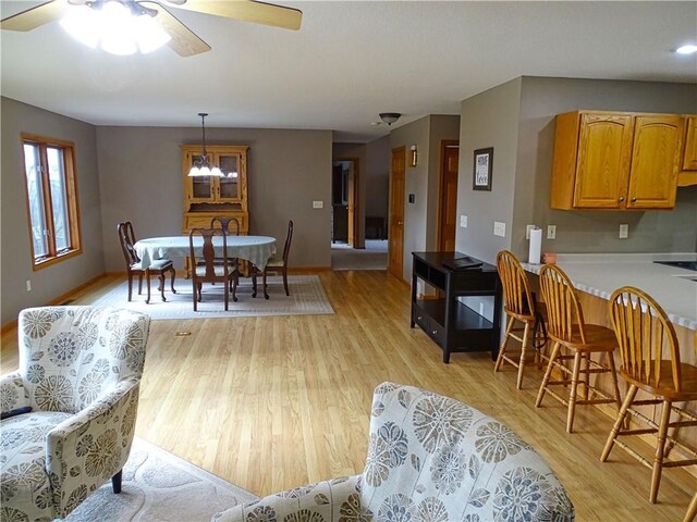 N1698 945th St, Eau Claire, WI 54701 - interior space with light wood finished floors, baseboards, and ceiling fan with notable chandelier