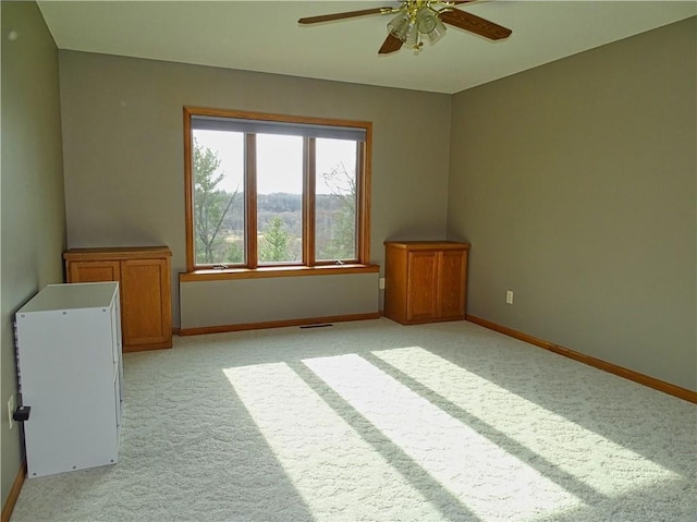 N1698 945th St, Eau Claire, WI 54701 - unfurnished room with baseboards, visible vents, a ceiling fan, and light colored carpet