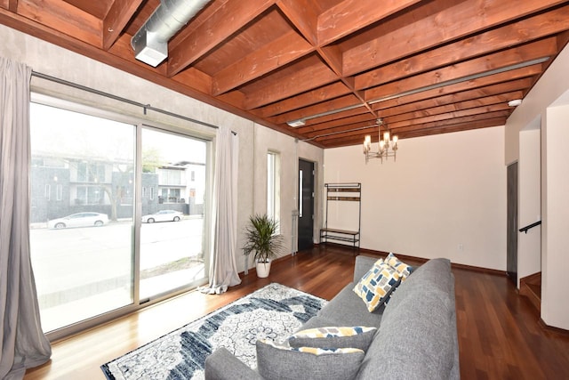 living area with an inviting chandelier, baseboards, and wood finished floors