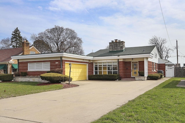 7709 3rd Ave, Kenosha, WI 53143 - view of front of house featuring a chimney, concrete driveway, a front lawn, an attached garage, and brick siding