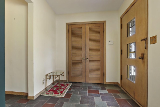 7709 3rd Ave, Kenosha, WI 53143 - foyer entrance with baseboards and stone tile flooring