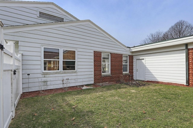 7709 3rd Ave, Kenosha, WI 53143 - back of house with brick siding and a lawn