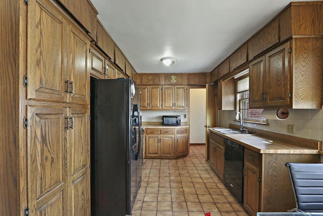 7709 3rd Ave, Kenosha, WI 53143 - kitchen with tasteful backsplash, a sink, black appliances, light tile patterned flooring, and light countertops