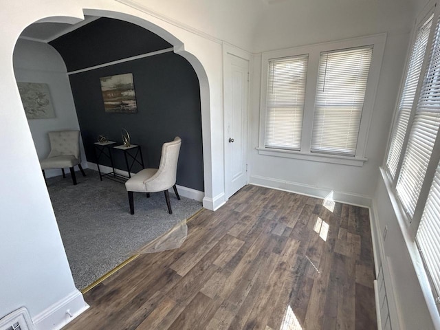 4271 N 26th St, Milwaukee, WI 53209 - living area with baseboards, wood finished floors, and arched walkways