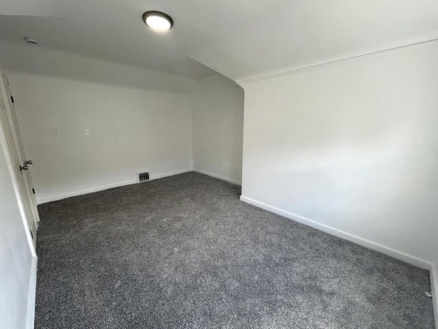 4271 N 26th St, Milwaukee, WI 53209 - bonus room featuring baseboards, vaulted ceiling, visible vents, and dark carpet