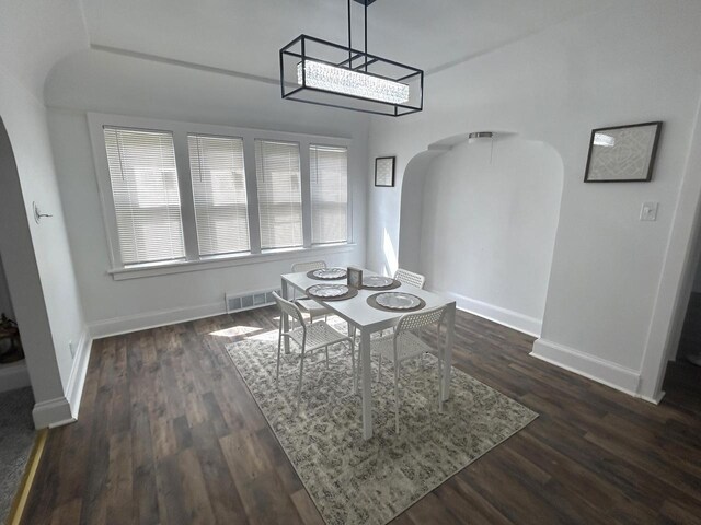 4271 N 26th St, Milwaukee, WI 53209 - unfurnished dining area with arched walkways, visible vents, and baseboards
