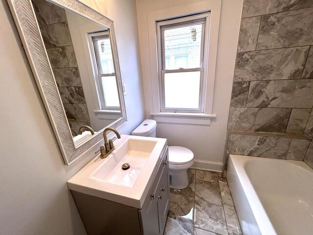4271 N 26th St, Milwaukee, WI 53209 - bathroom featuring a bathtub, toilet, baseboards, marble finish floor, and vanity