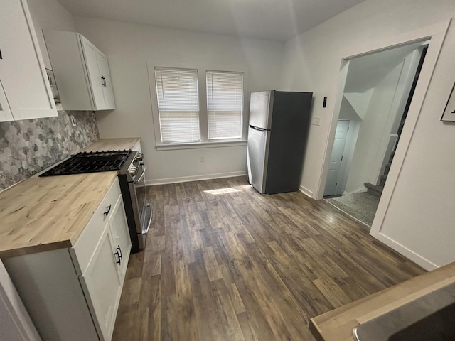 4271 N 26th St, Milwaukee, WI 53209 - kitchen with white cabinets, wooden counters, stainless steel appliances, dark wood-style floors, and decorative backsplash