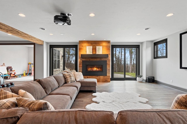 6916 N Palladium Ct, Appleton, WI 54913 - living room featuring recessed lighting, a fireplace, baseboards, and wood finished floors