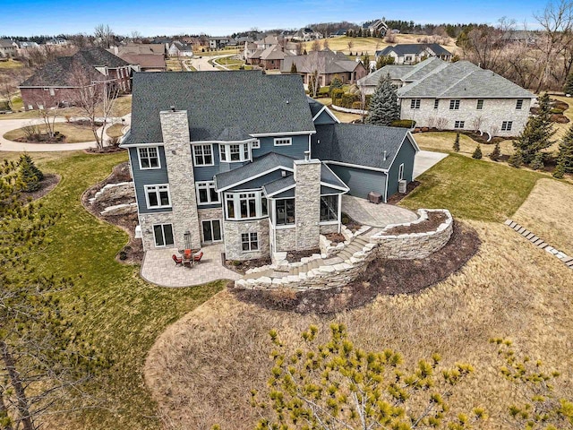 6916 N Palladium Ct, Appleton, WI 54913 - rear view of house with a residential view, a patio, stone siding, and a chimney