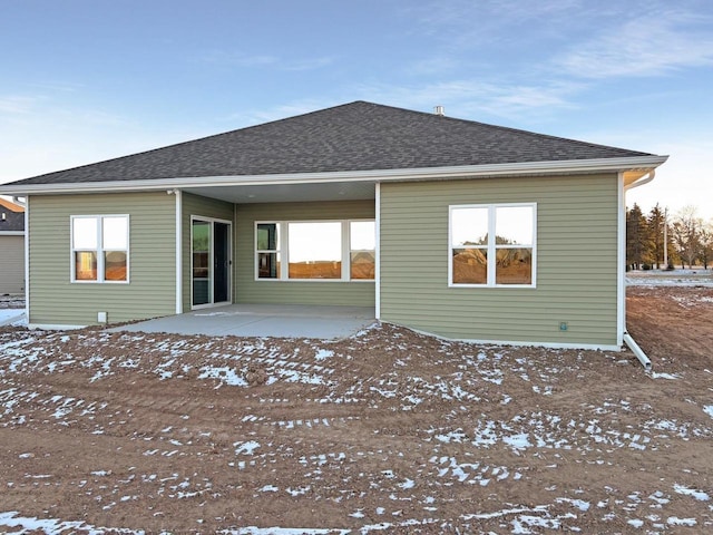 418 Toms Way, Luxemburg, WI 54217 - snow covered back of property featuring a patio area and a shingled roof