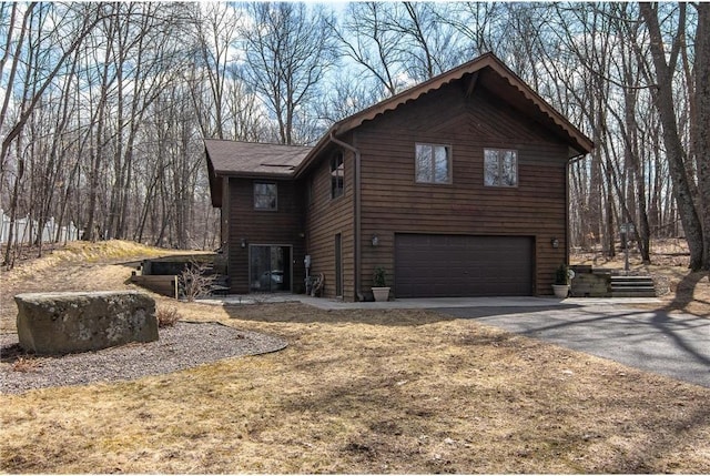 840 Park Dr, Balsam Lake, WI 54810 - view of side of property featuring an attached garage and driveway
