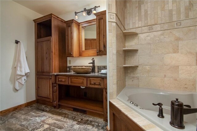 840 Park Dr, Balsam Lake, WI 54810 - bathroom featuring stone finish floor, baseboards, a whirlpool tub, and vanity