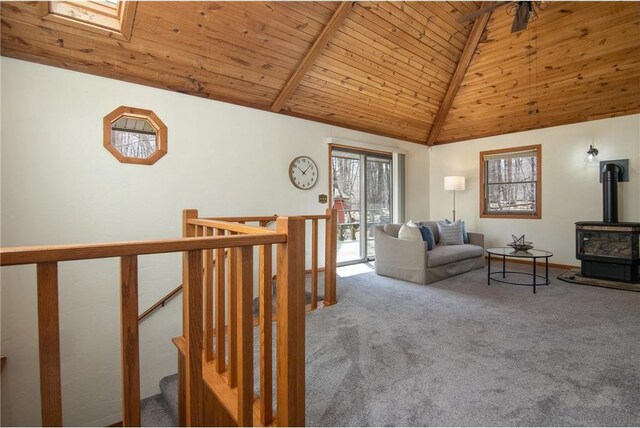 840 Park Dr, Balsam Lake, WI 54810 - living area with carpet, a wood stove, vaulted ceiling with beams, and wood ceiling