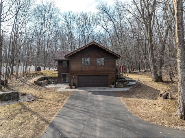 840 Park Dr, Balsam Lake, WI 54810 - view of home's exterior featuring an attached garage and aphalt driveway