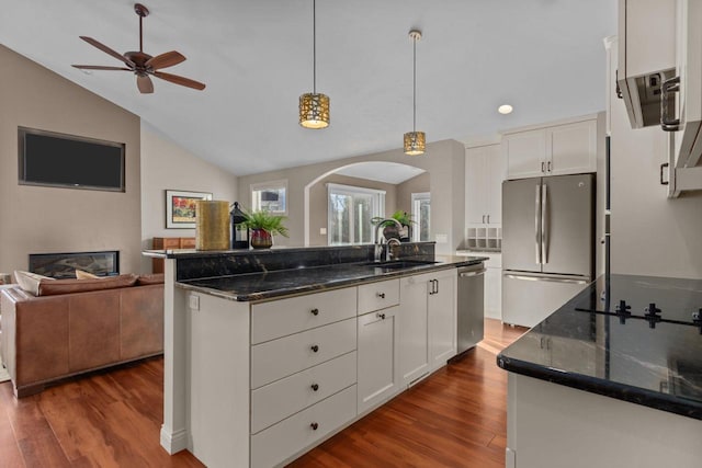 4923 W Woods Creek Ln, Appleton, WI 54913 - kitchen with appliances with stainless steel finishes, arched walkways, a sink, open floor plan, and white cabinetry