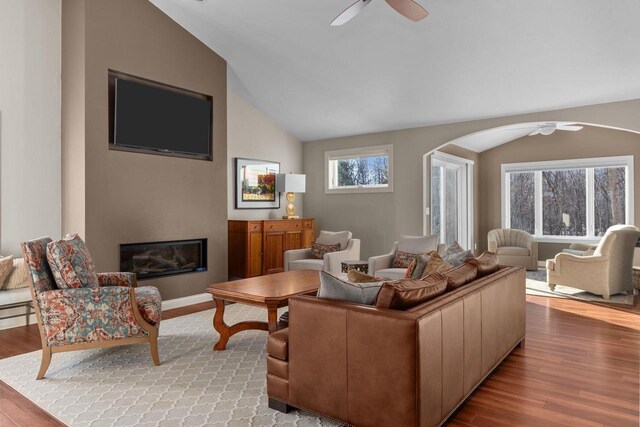 4923 W Woods Creek Ln, Appleton, WI 54913 - living area with a ceiling fan, a glass covered fireplace, wood finished floors, and vaulted ceiling