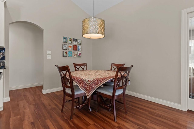 4923 W Woods Creek Ln, Appleton, WI 54913 - dining space featuring baseboards, arched walkways, dark wood-style flooring, and lofted ceiling