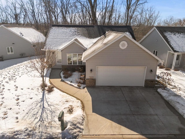 4923 W Woods Creek Ln, Appleton, WI 54913 - view of front facade with brick siding, an attached garage, and driveway