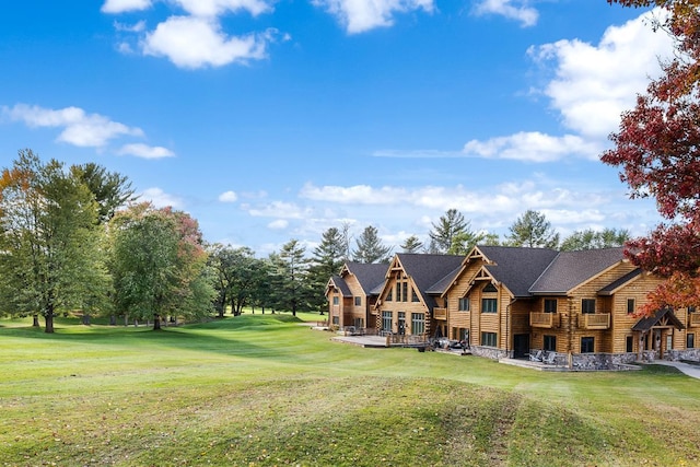 exterior space featuring a lawn and log exterior