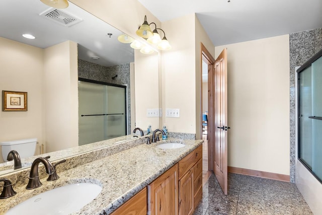 bathroom featuring visible vents, toilet, a shower with door, and a sink