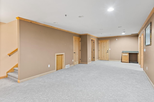 below grade area with stairway, light colored carpet, baseboards, visible vents, and recessed lighting