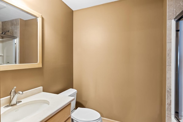 full bath with toilet, walk in shower, and vanity