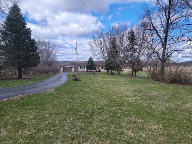 S5026 Greenfield Ln, Baraboo, WI 53913 - view of front of house with a garage, a front yard, and aphalt driveway