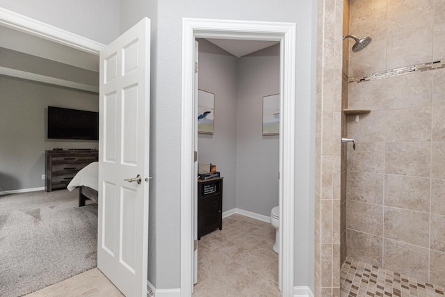 bathroom with tile patterned floors, toilet, a stall shower, and connected bathroom