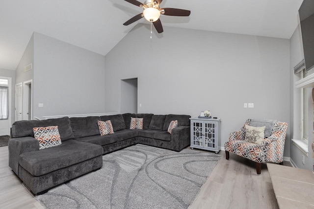 living room with visible vents, wood finished floors, high vaulted ceiling, and ceiling fan