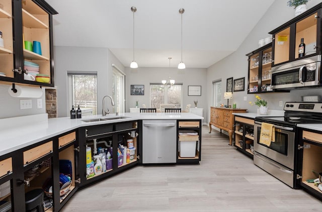 kitchen featuring open shelves, a wealth of natural light, appliances with stainless steel finishes, and a sink