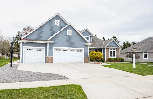 craftsman-style house featuring an attached garage, driveway, brick siding, and a front yard