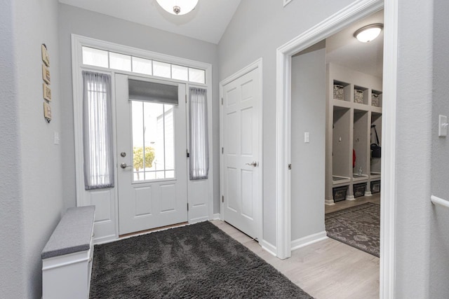 entryway featuring wood finished floors and baseboards