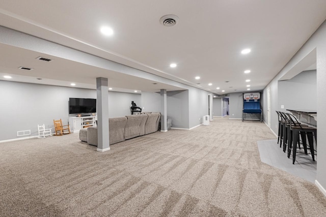 carpeted living room with baseboards, visible vents, and recessed lighting