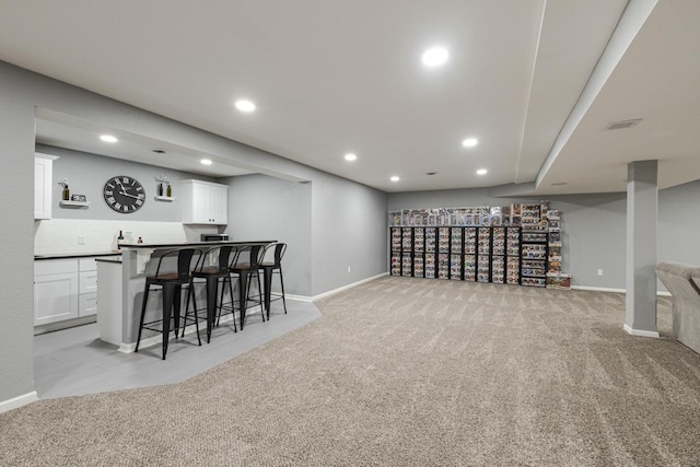 bar with recessed lighting, light carpet, baseboards, decorative backsplash, and indoor wet bar