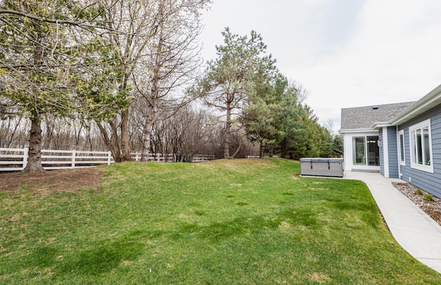 view of yard featuring a fenced backyard and a hot tub