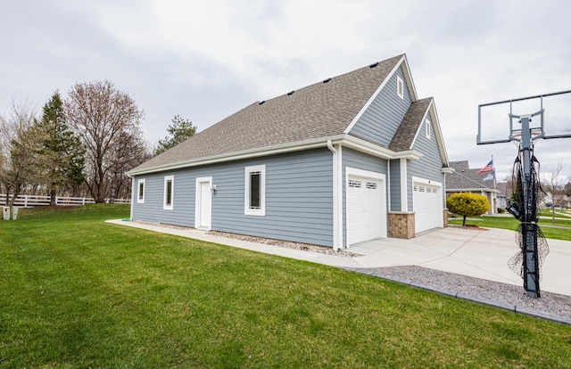 view of property exterior featuring roof with shingles, driveway, fence, a garage, and a yard