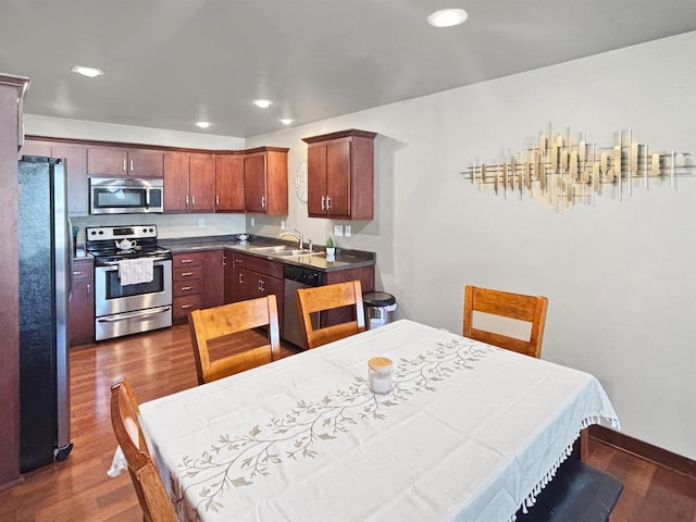 302 N Van Buren St, Green Bay, WI 54301 - kitchen with dark countertops, a sink, appliances with stainless steel finishes, dark wood-style floors, and recessed lighting