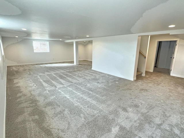 basement featuring recessed lighting, stairway, and carpet flooring