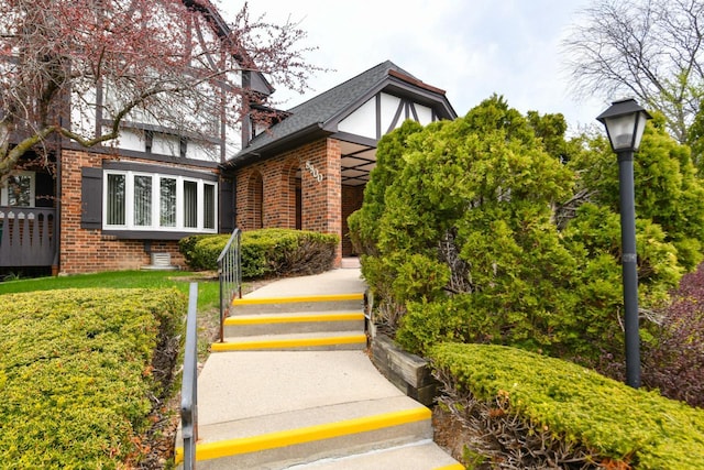 entrance to property featuring brick siding