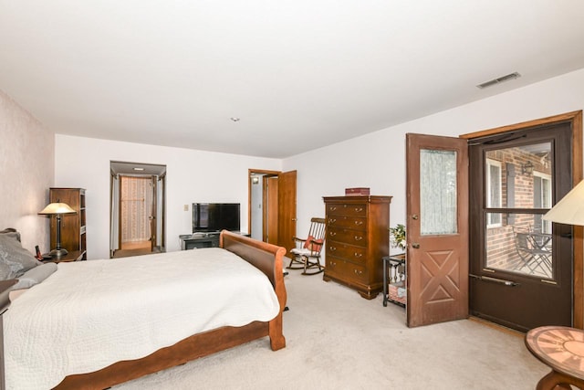 bedroom featuring visible vents and light carpet