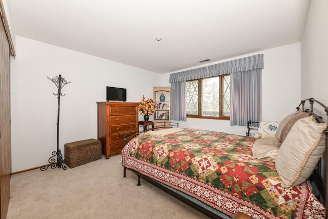 bedroom with light colored carpet and visible vents