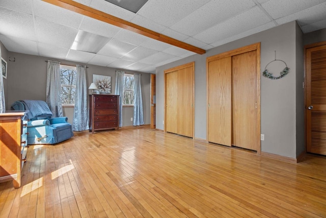 interior space featuring light wood-style floors and a drop ceiling