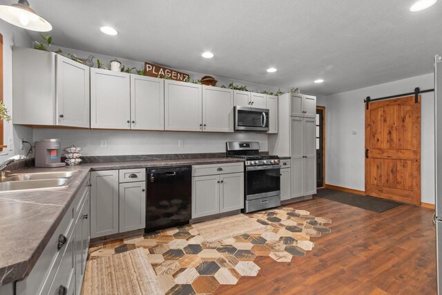 kitchen with recessed lighting, light wood-style floors, stainless steel appliances, and a sink